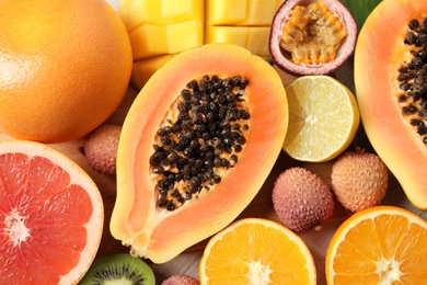 Fresh ripe papaya and other fruits on table, top view