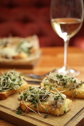 Delicious bruschettas with fish on table, closeup