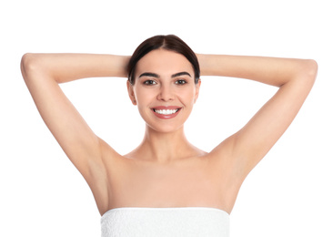 Photo of Young woman showing hairless armpits after epilation procedure on white background