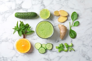 Photo of Flat lay composition with glass of delicious detox juice and ingredients on marble background