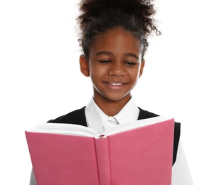 Happy African-American girl in school uniform reading book on white background