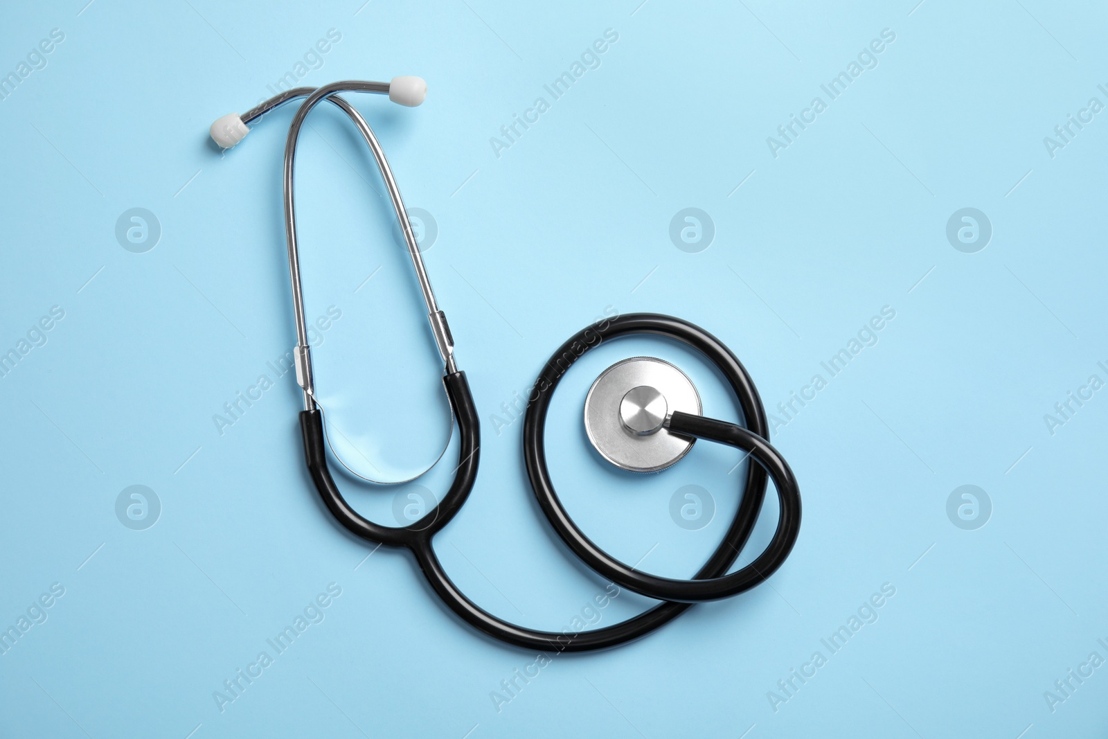 Photo of Stethoscope on color background, top view. Medical tool