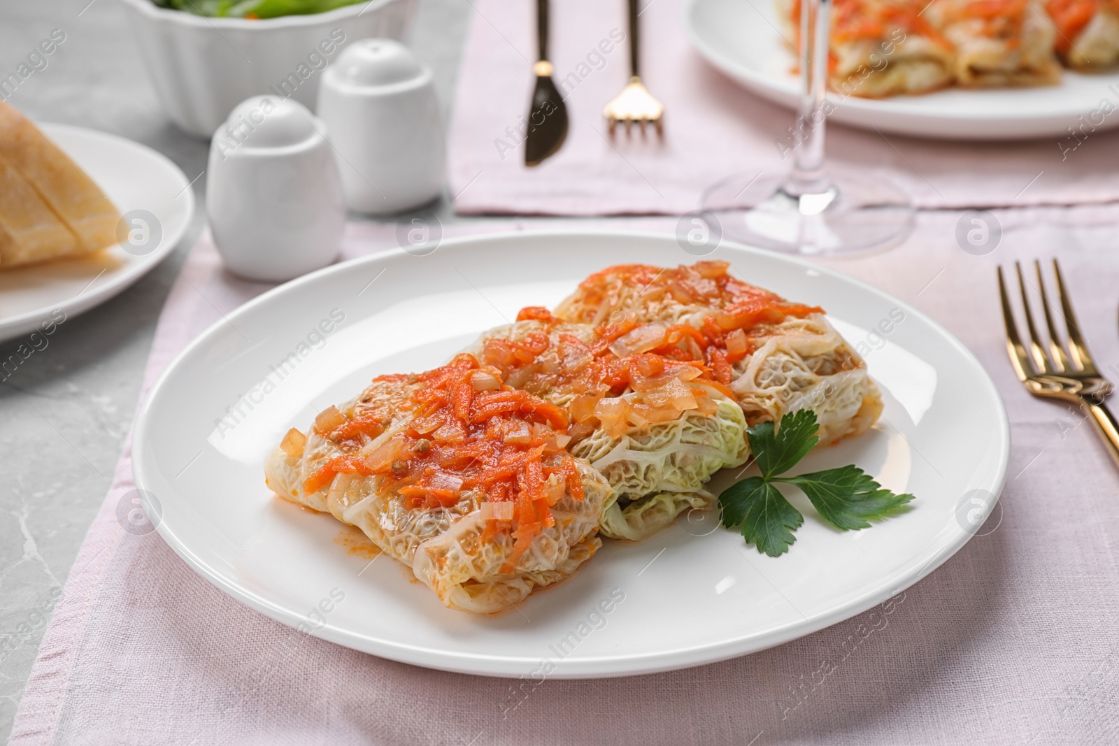 Photo of Delicious cabbage rolls served on grey table