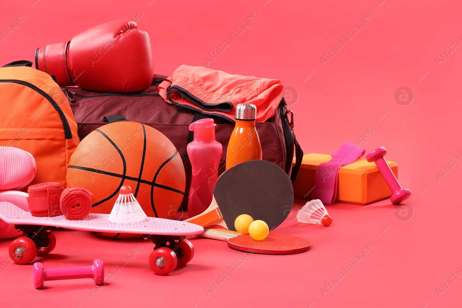 Photo of Many different sports equipment on red background