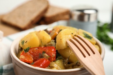 Tasty cooked dish with potatoes in earthenware, closeup