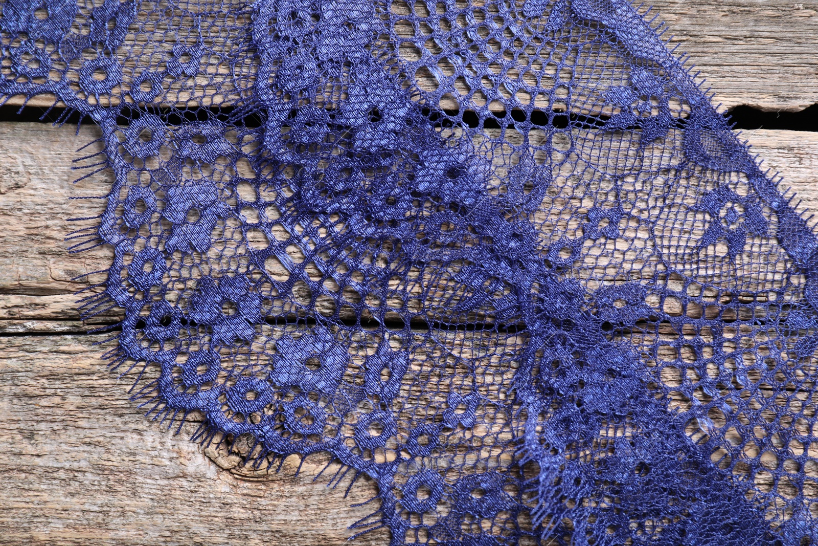 Photo of Beautiful lace on wooden table, top view