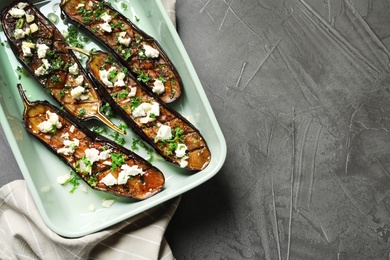 Photo of Baking dish with fried eggplant slices on grey background, top view. Space for text