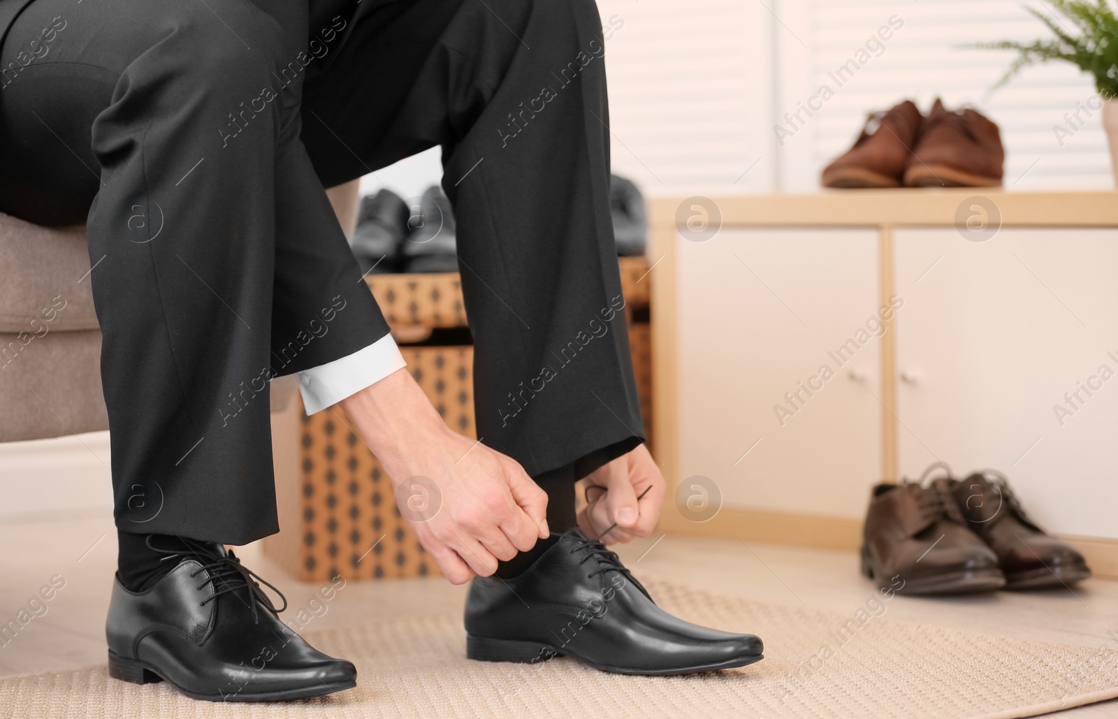 Photo of Young man trying on shoes in store