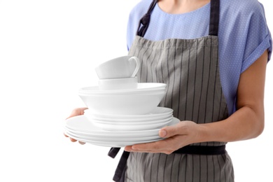 Woman with clean dishes and cups on white background, closeup