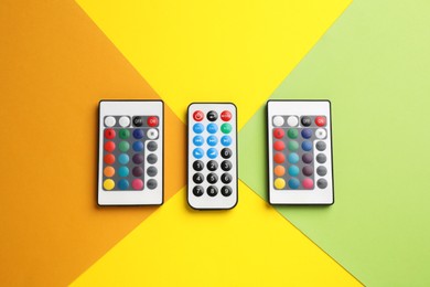 Photo of Different remote controls on color background, flat lay