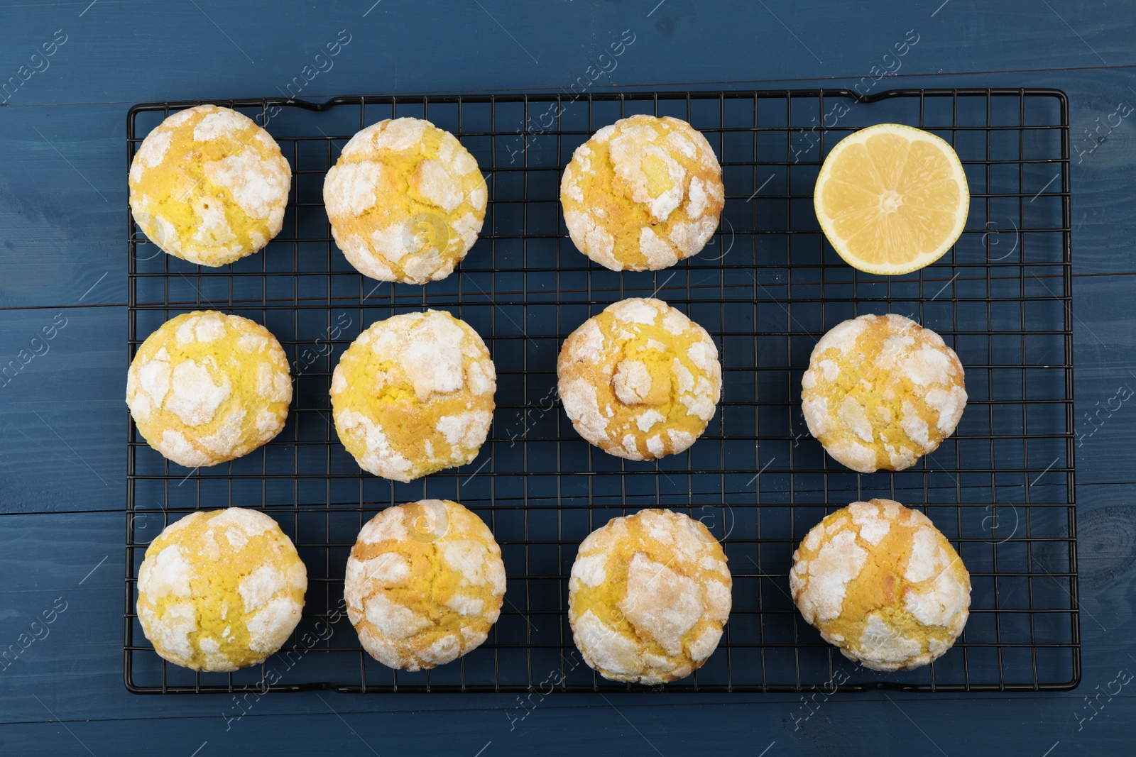 Photo of Tasty homemade lemon cookies on blue wooden table, top view