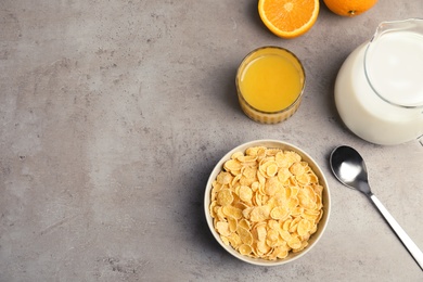 Photo of Flat lay composition with healthy cornflakes in bowl on table. Space for text