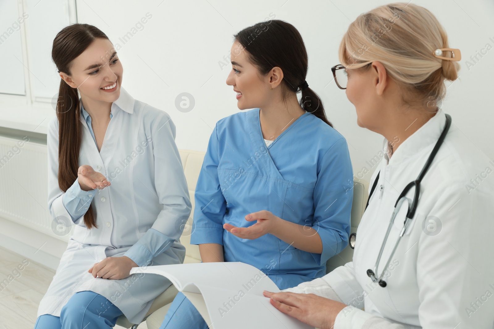 Photo of Team of professional doctors having discussion in clinic