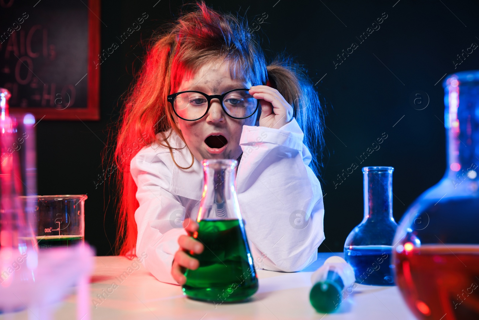 Photo of Child doing chemical research in laboratory. Dangerous experiment