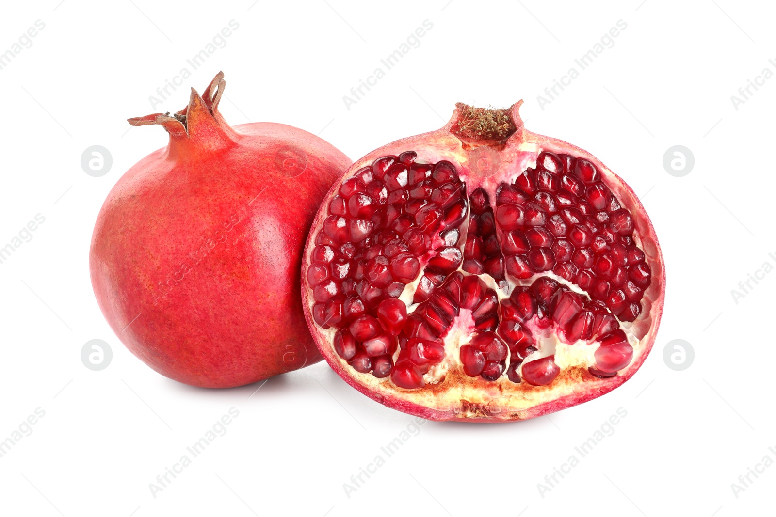 Photo of Half and whole pomegranates isolated on white