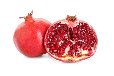 Half and whole pomegranates isolated on white