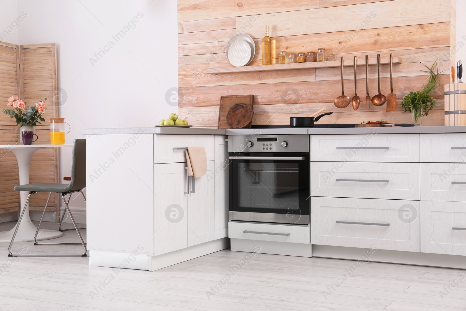 Photo of Light modern kitchen interior with new oven