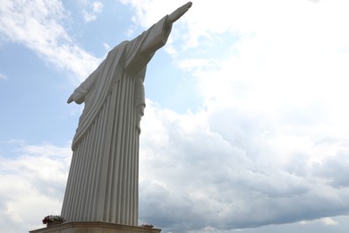 Photo of Truskavets, Ukraine - July 22, 2023: Beautiful statue of Christ the Redeemer against cloudy blue sky, low angle view. Space for text