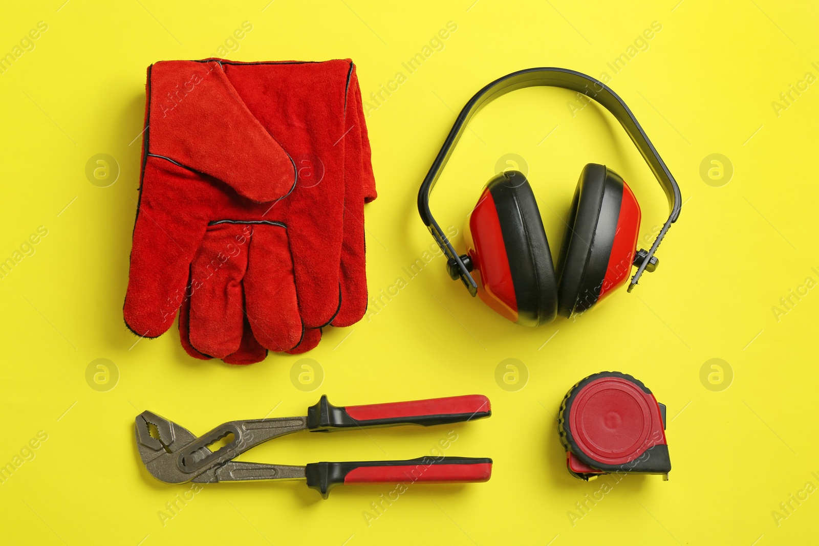 Photo of Flat lay composition with safety equipment on color background