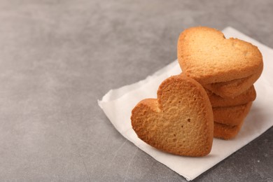 Heart shaped Danish butter cookies on grey table, closeup. Space for text