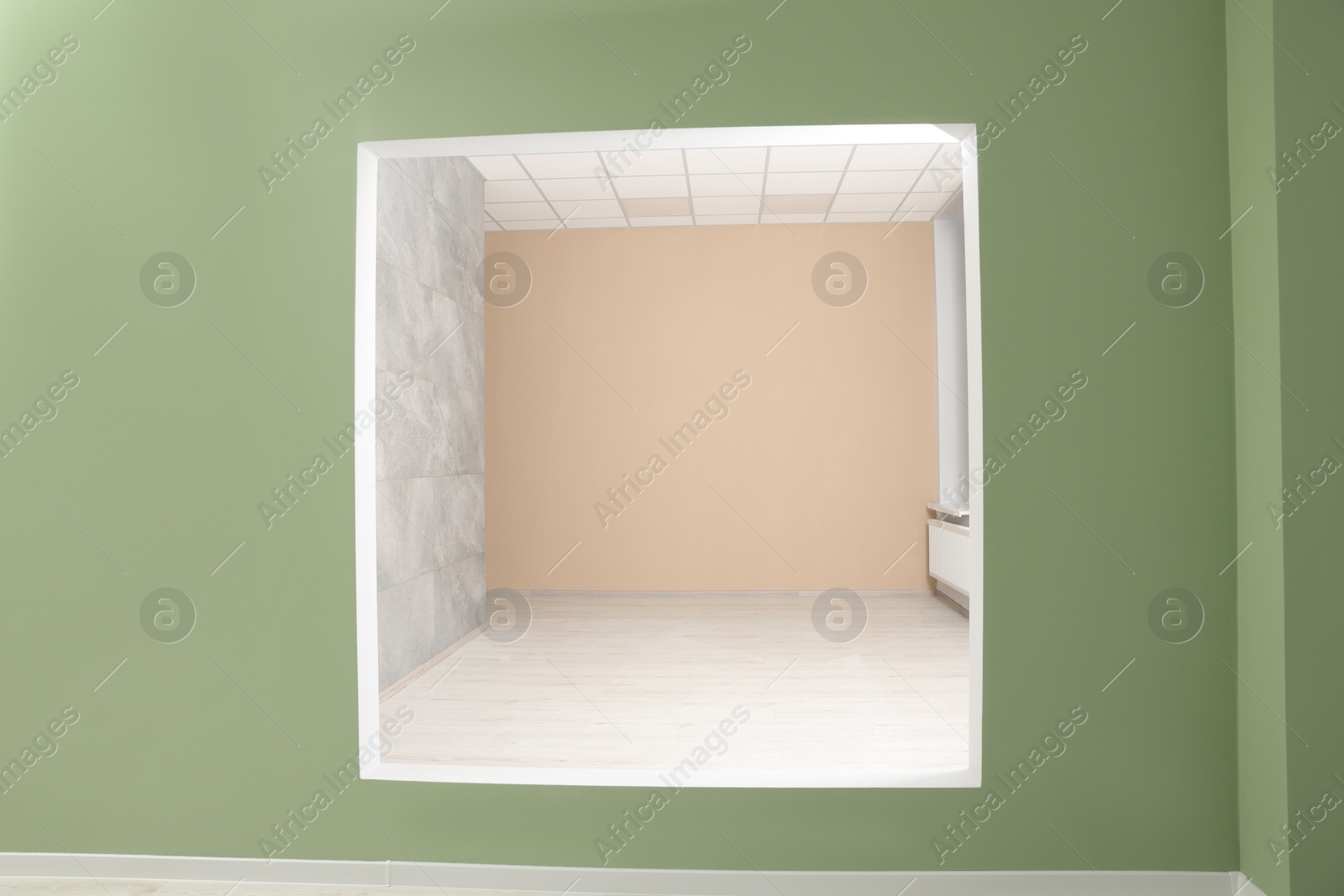 Photo of Empty office room with color walls. Opening for fake window