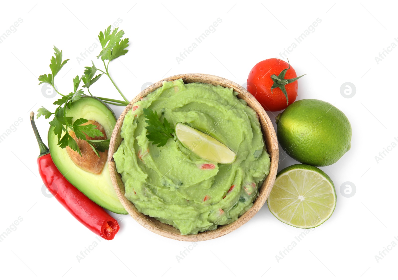Photo of Bowl of delicious guacamole and ingredients isolated on white, top view
