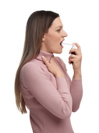 Woman using throat spray on white background