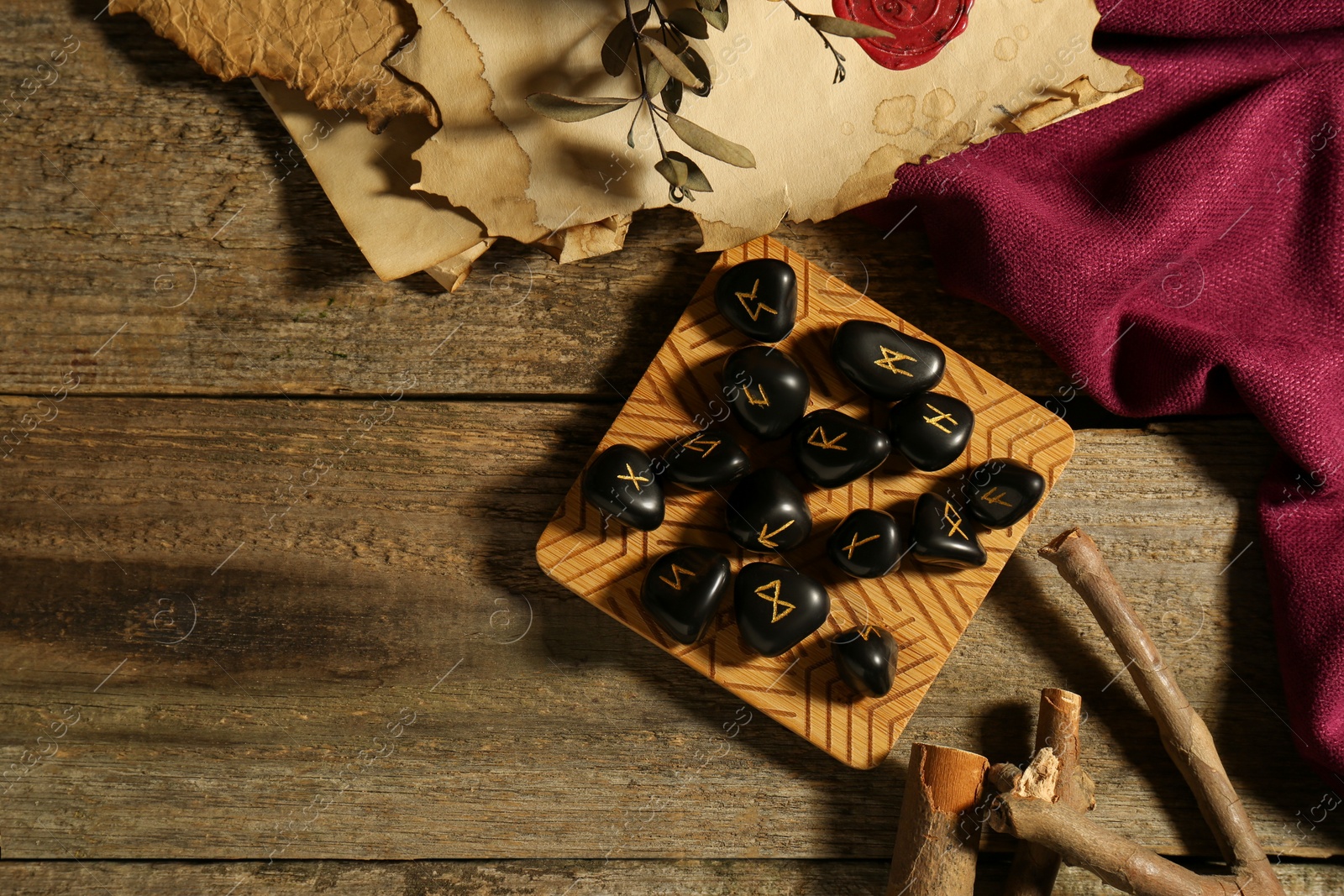 Photo of Composition with black rune stones on wooden table, flat lay. Space for text