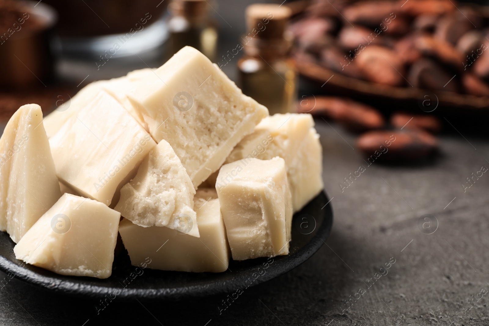 Photo of Organic cocoa butter on grey table, closeup