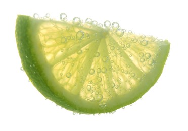 Photo of Slice of lime in sparkling water on white background. Citrus soda