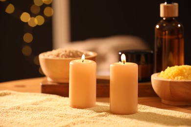 Spa composition with burning candles and personal care products on soft light surface, closeup