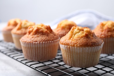 Photo of Delicious sweet muffins on grey table, closeup