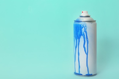 Photo of Used can of spray paint on color background. Space for text