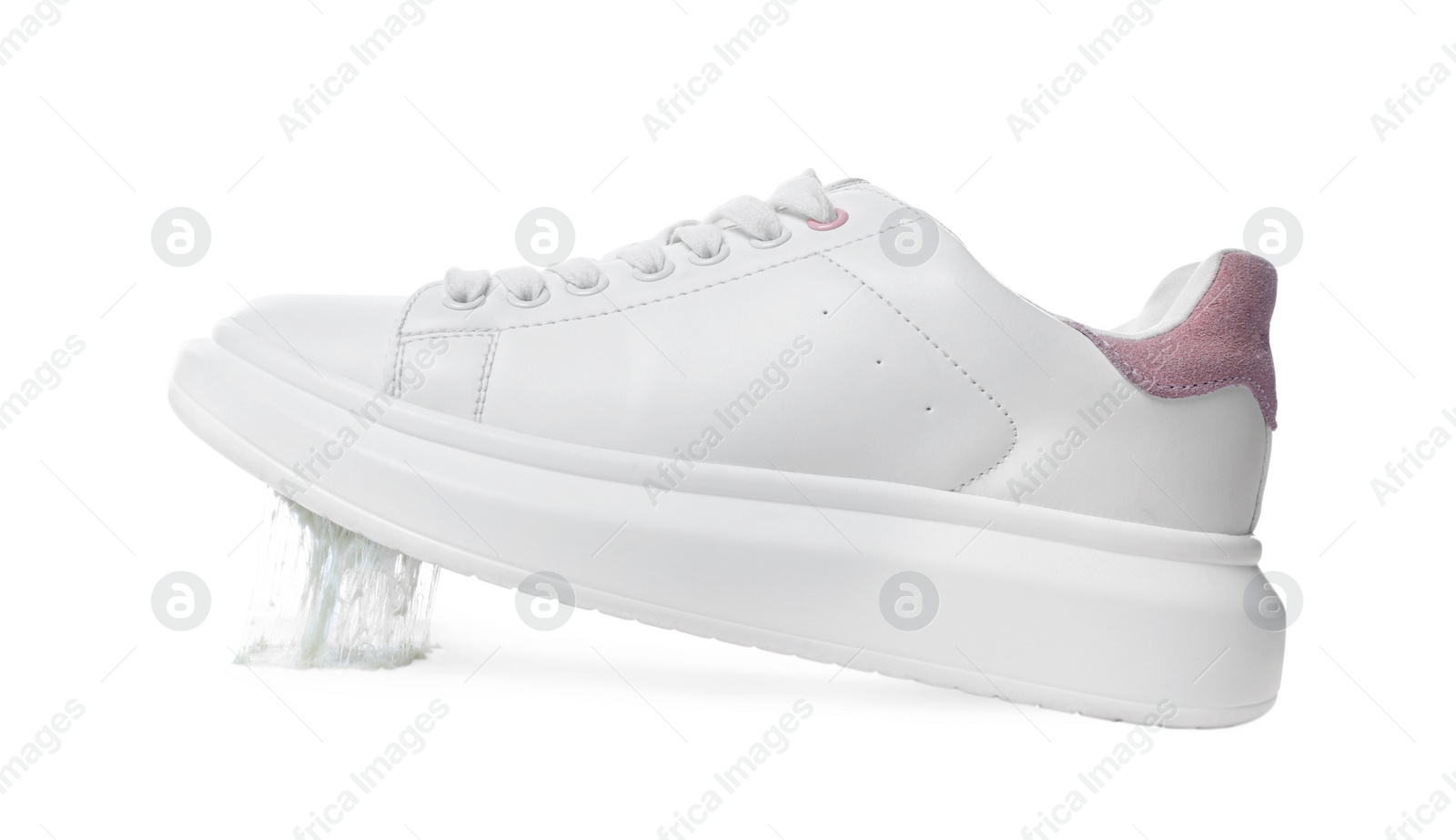 Photo of Shoe with chewing gum on sole against white background