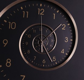 Image of Infinity and other time related concepts. Clock hands and twisted hour numbers. Spiral effect