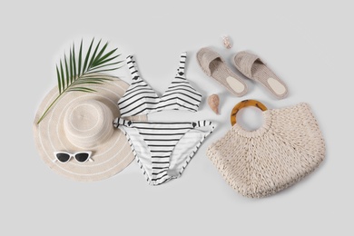 Flat lay composition with beach accessories on white background