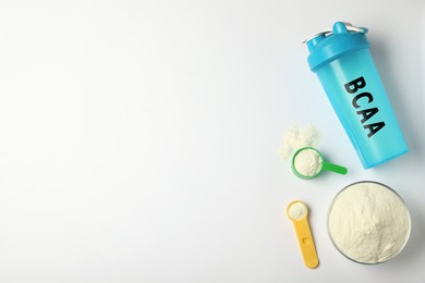 Image of Shaker with abbreviation BCAA (Branched-chain amino acid) and powder on white background, flat lay. Space for text 