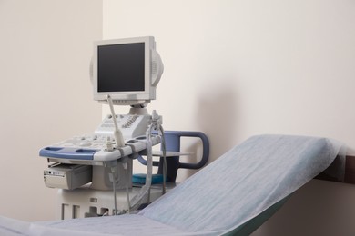 Photo of Ultrasound machine and examination table in hospital