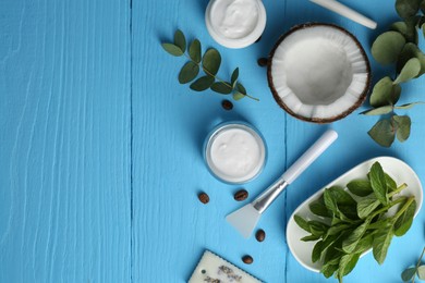 Photo of Flat lay composition with homemade cosmetic products and fresh ingredients on light blue wooden table. Space for text