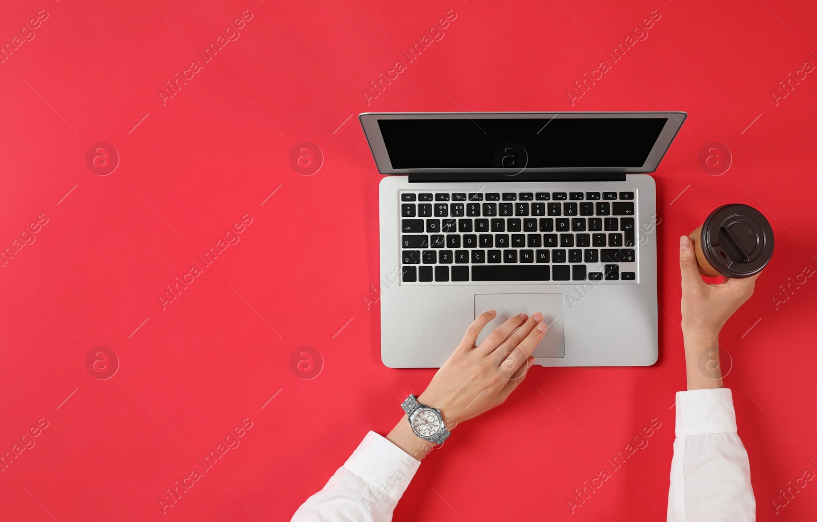 Photo of Woman with cup of coffee using modern laptop, top view. Space for text