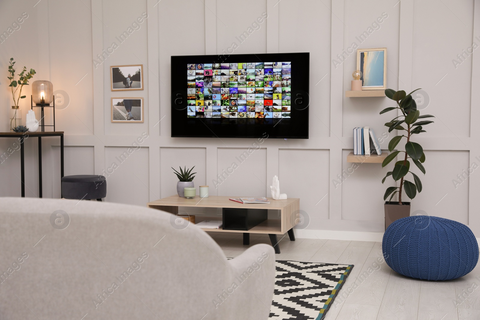 Photo of Stylish living room interior with modern TV on white wall