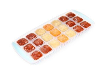 Photo of Different puree in ice cube tray on white background. Ready for freezing