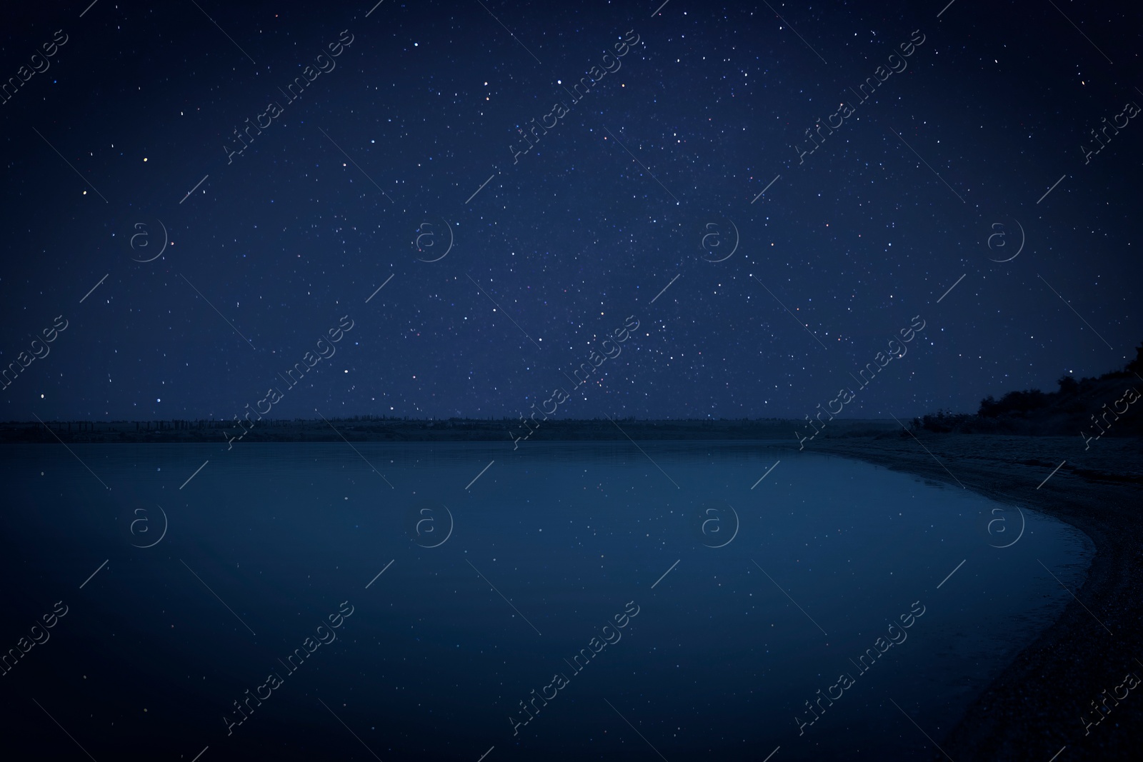 Image of Amazing starry sky reflecting in lake at night