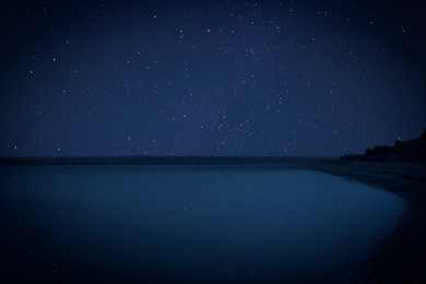 Image of Amazing starry sky reflecting in lake at night