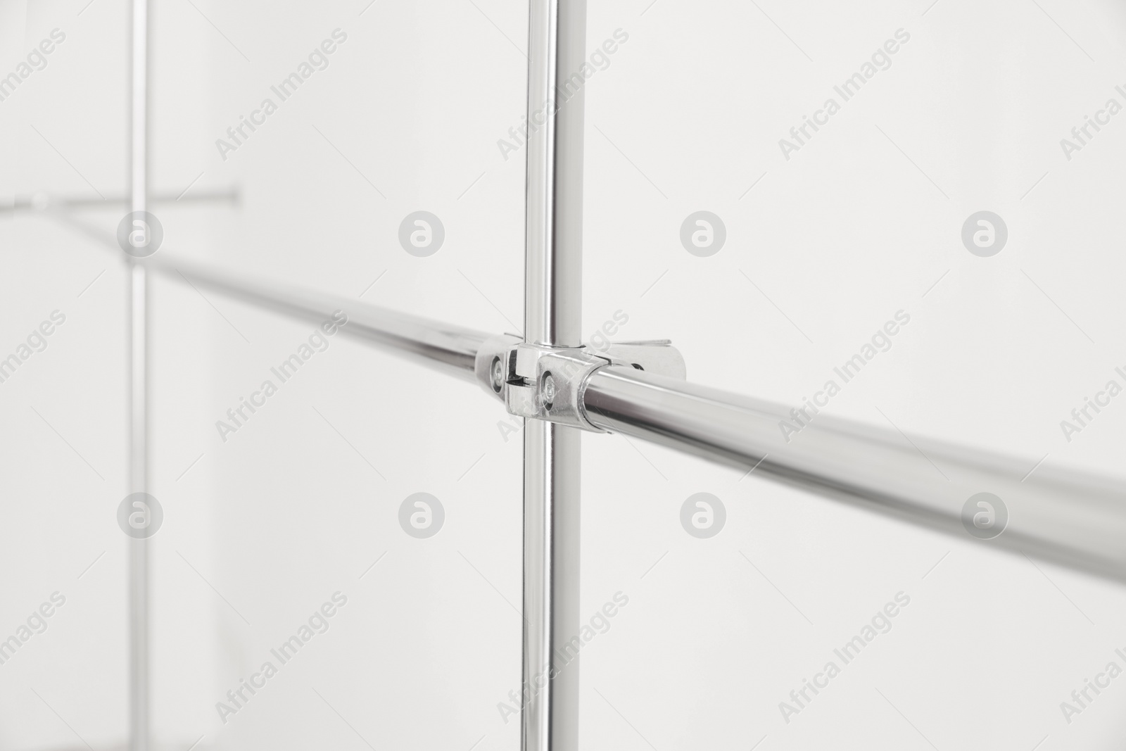 Photo of New modern metal pipes against white background