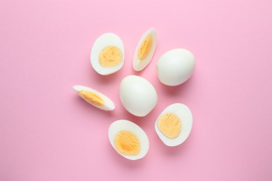 Photo of Fresh hard boiled eggs on pink background, flat lay
