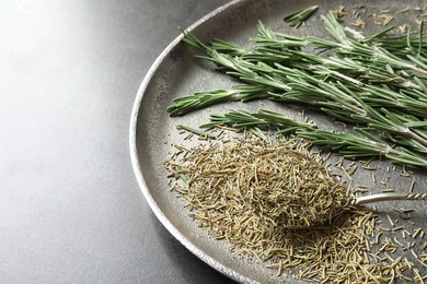 Photo of Plate with dried rosemary and twigs on table, closeup