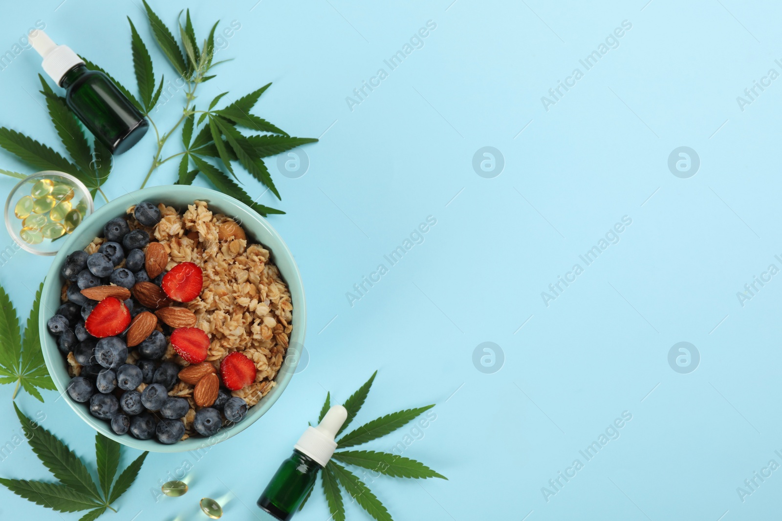 Photo of CBD oil, THC tincture, oatmeal bowl and hemp leaves on light blue background, flat lay. Space for text