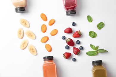 Photo of Flat lay composition with healthy detox smoothies and ingredients on light background