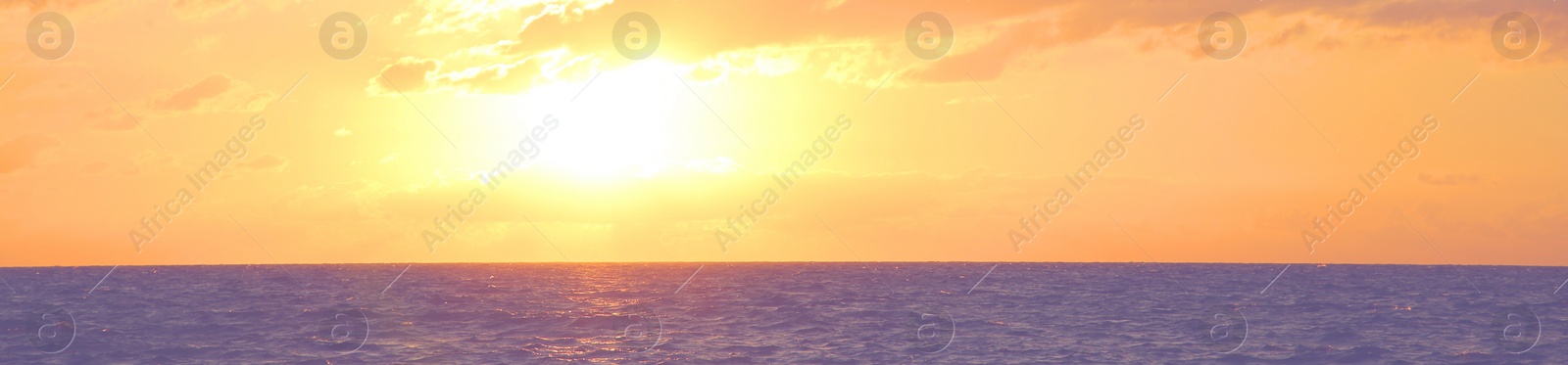 Image of Beautiful panorama of sky over sea at sunset. Banner design